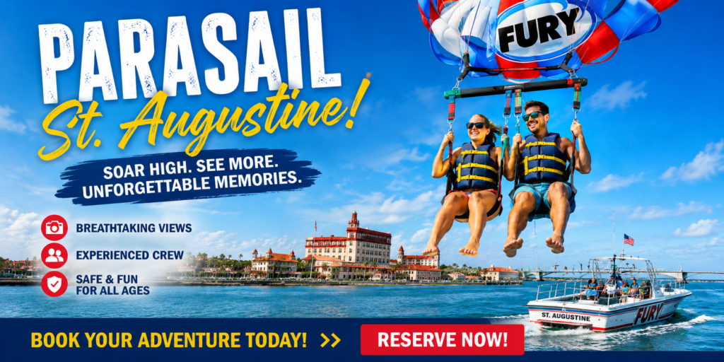 Couple parasailing high above Matanzas Bay with Fury Water Adventures overlooking historic downtown St. Augustine and the bayfront waterfront